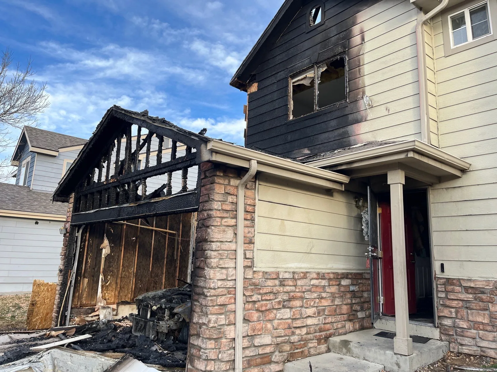 Assessing fire damage on the charred exterior of a Colorado home