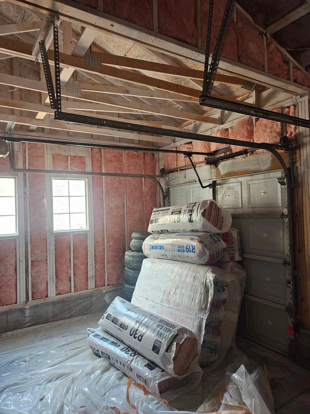 Rebuilding a fire-damaged garage, new framing and insulation going back in