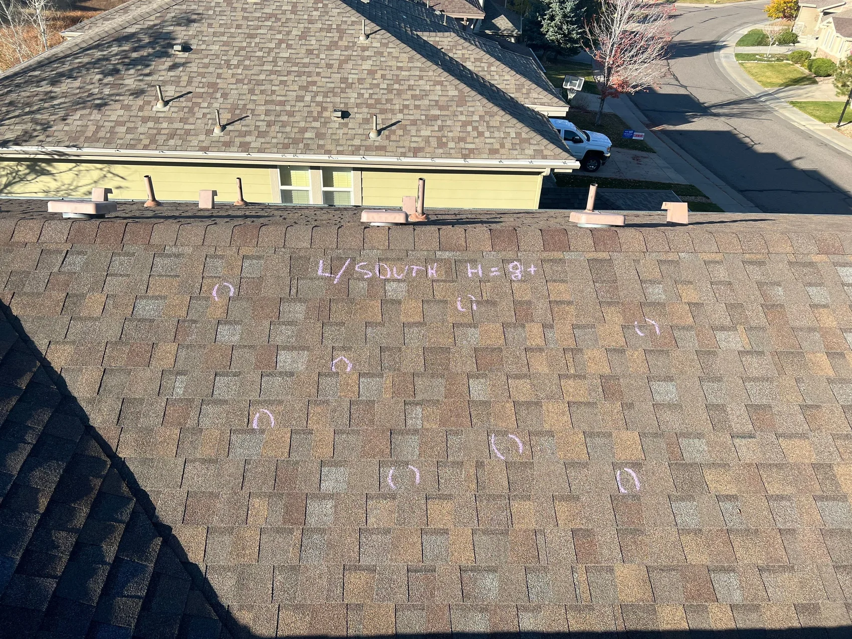 Hail strikes marked and documented on a Colorado roof for an insurance claim