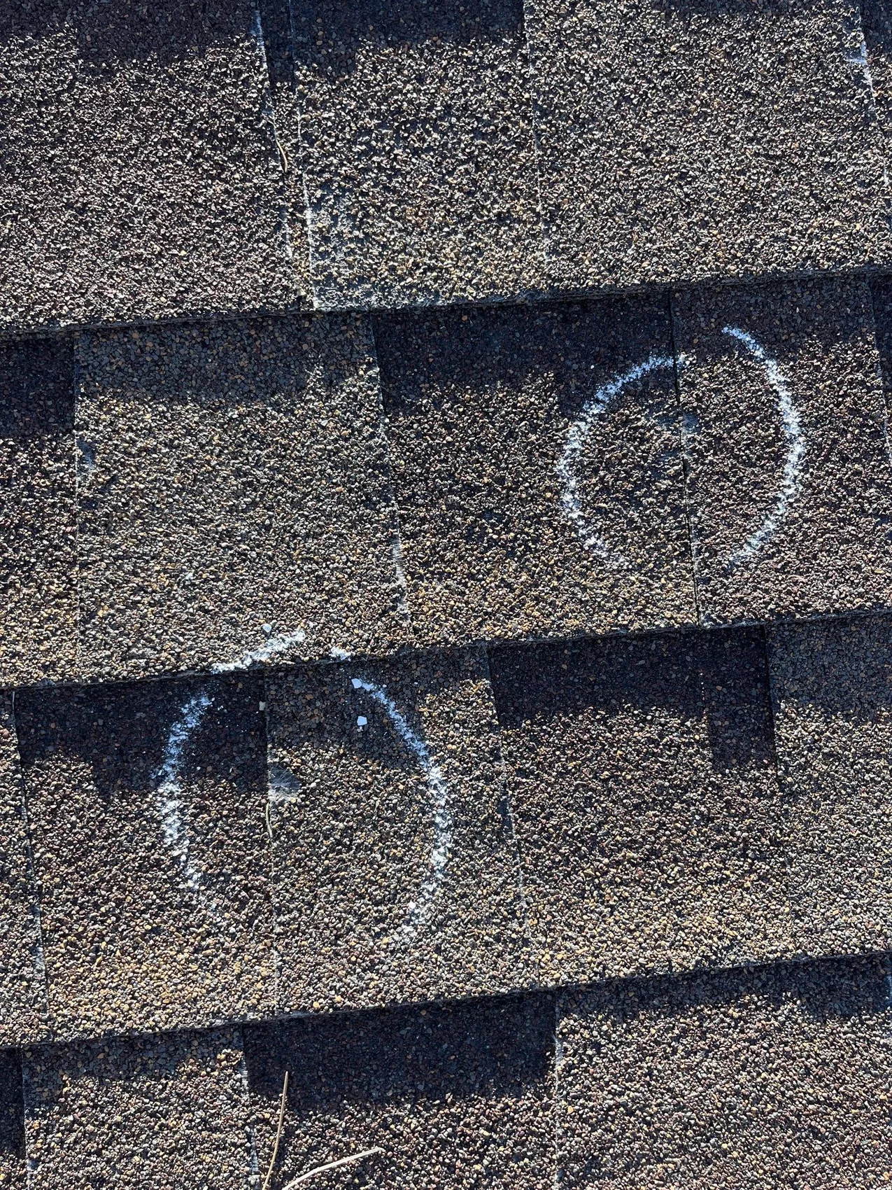 Hail strikes marked on a Colorado roof during a damage assessment