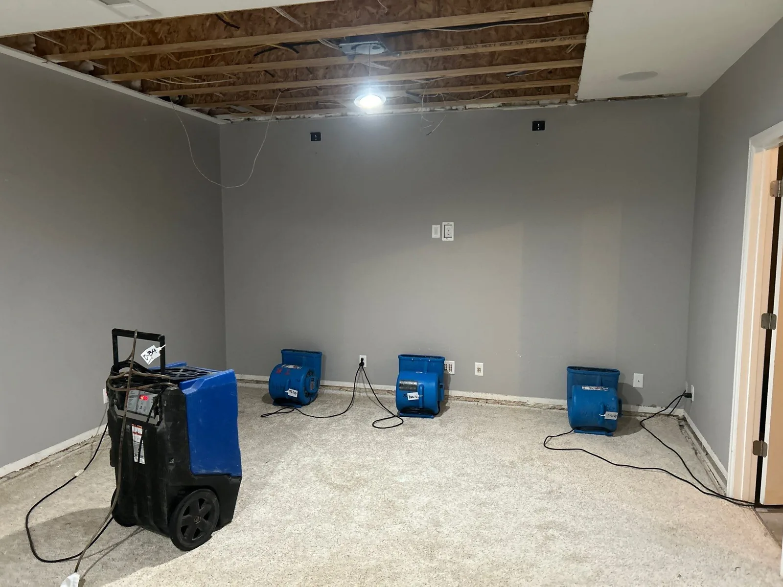 Dehumidifier and air movers structural drying a water-damaged Colorado room