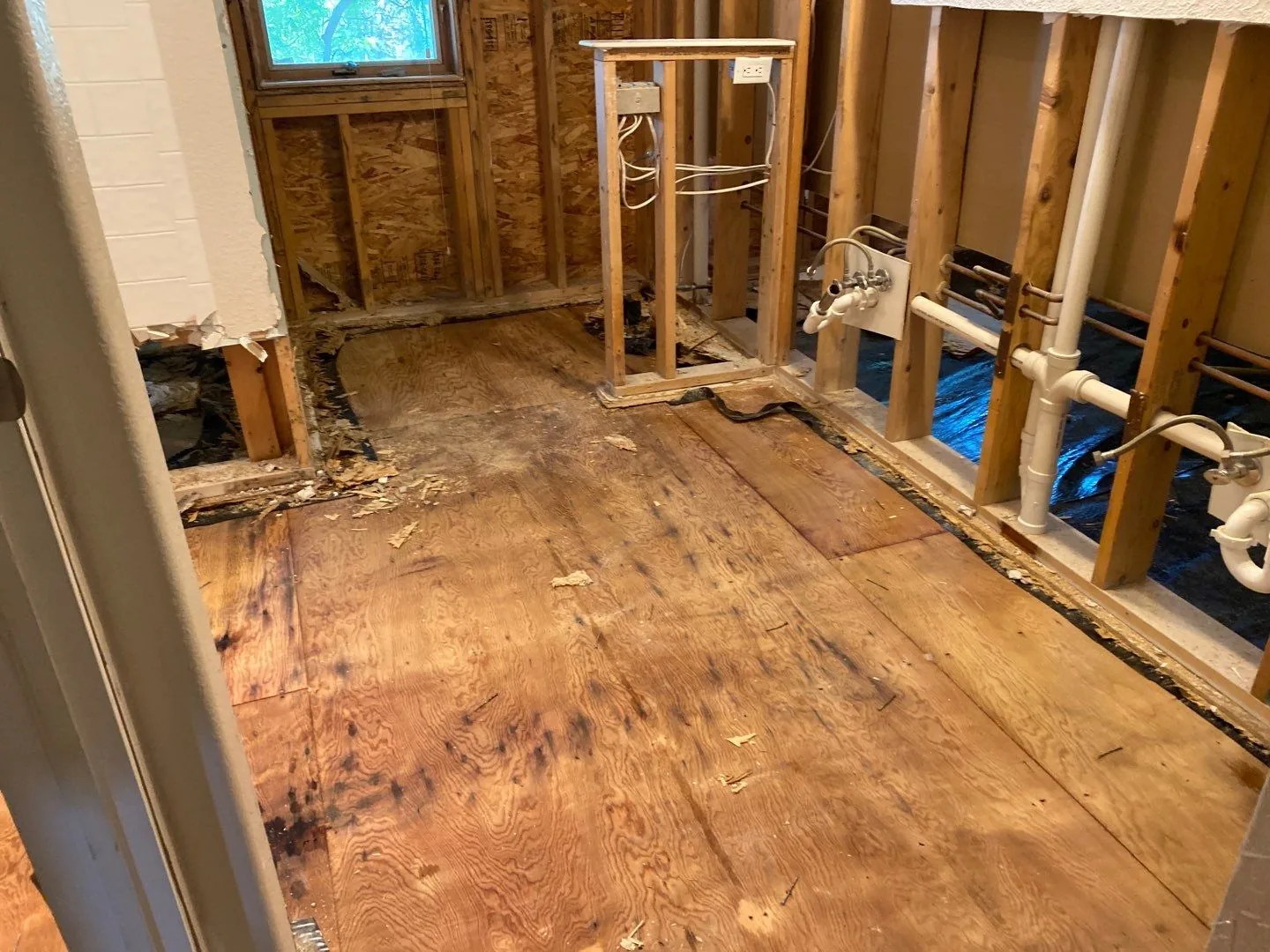 Water-damaged room stripped to the studs during flood-cut demolition