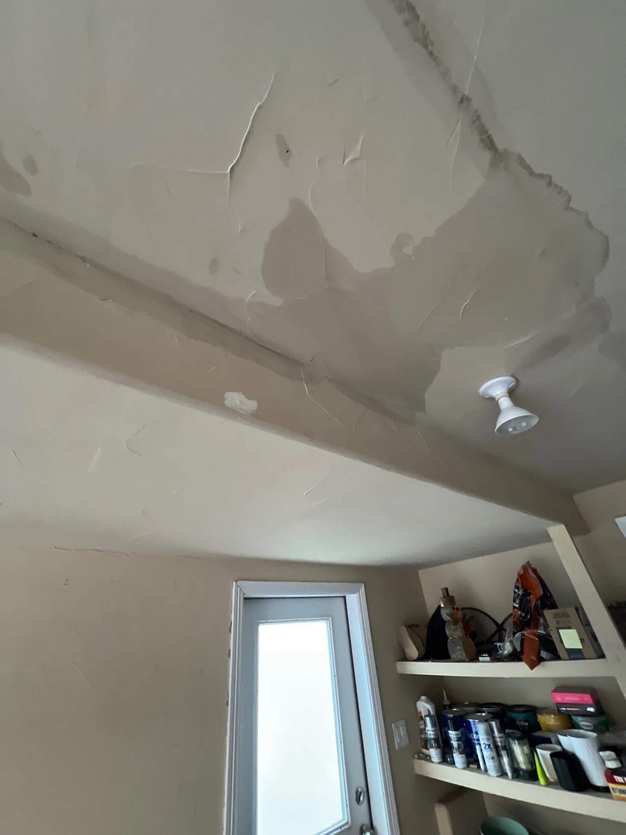 Water staining and bubbling a ceiling from a leak on the floor above