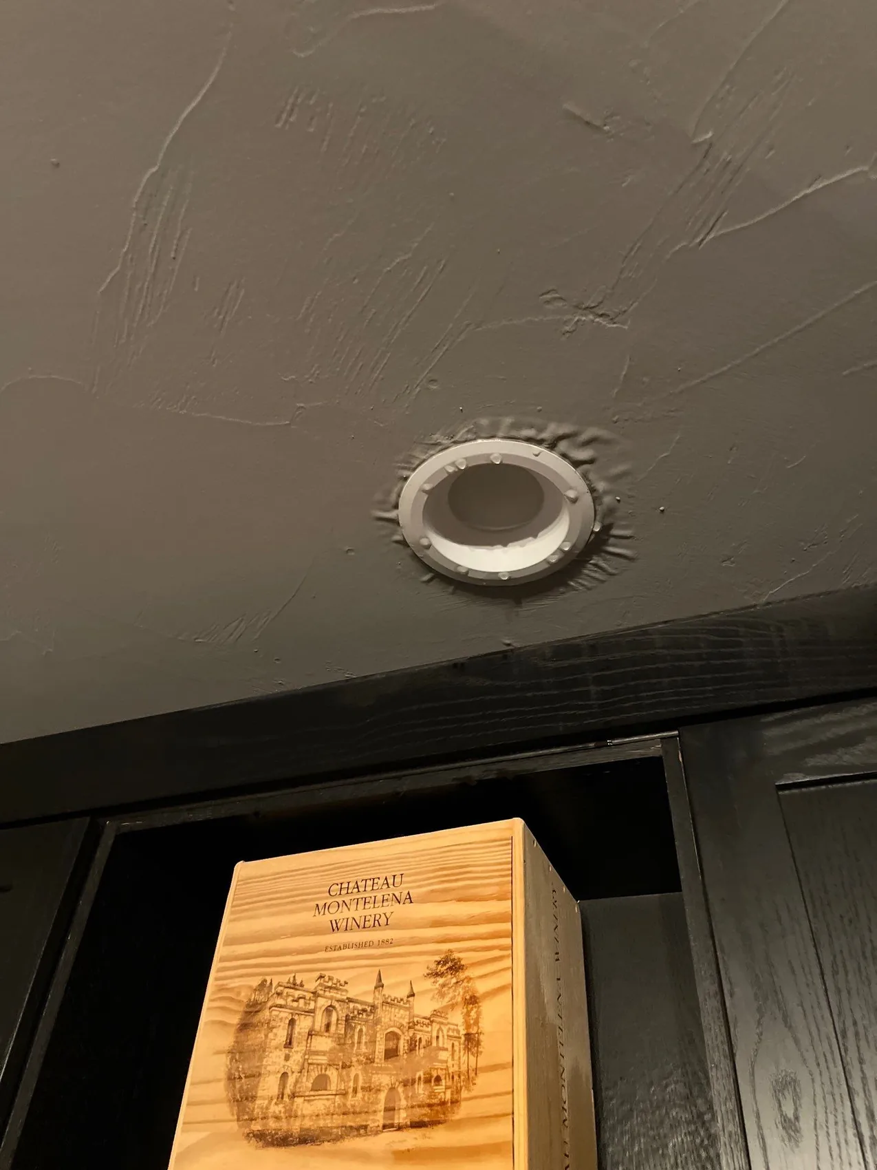 Water dripping from a recessed ceiling light after a leak overhead