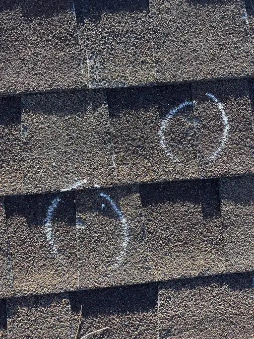 Hail strikes marked on a Colorado roof during a damage assessment