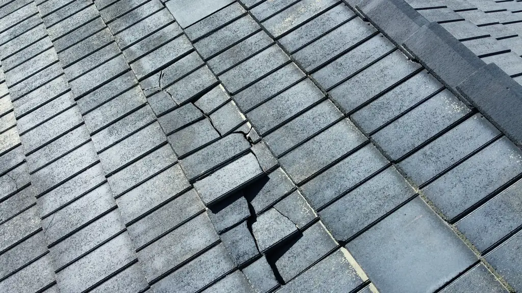 A cracked roof tile found during a close-up Colorado roof inspection